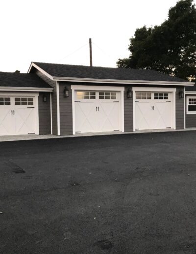 A garage with two garage doors and a driveway.