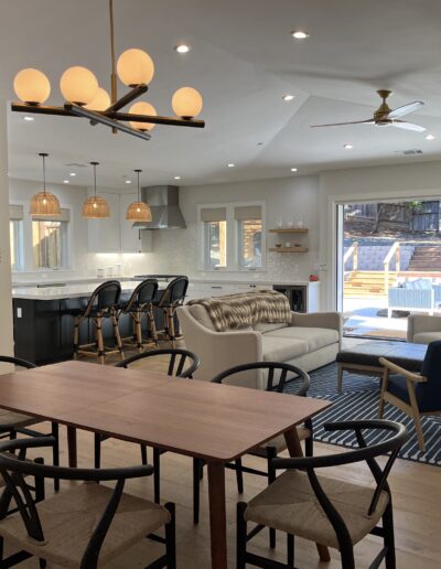 A living room with a dining table and chairs.